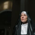 Co zrobić, gdy czujesz powołanie, ale masz długi, chorobę lub inne zobowiązania? Zakonnica pogrążona w modlitwie w ławce kościoła